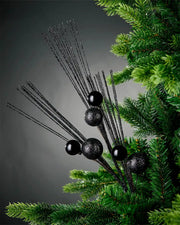 Black glitter bauble spray on Christmas tree full view of item in front of grey background