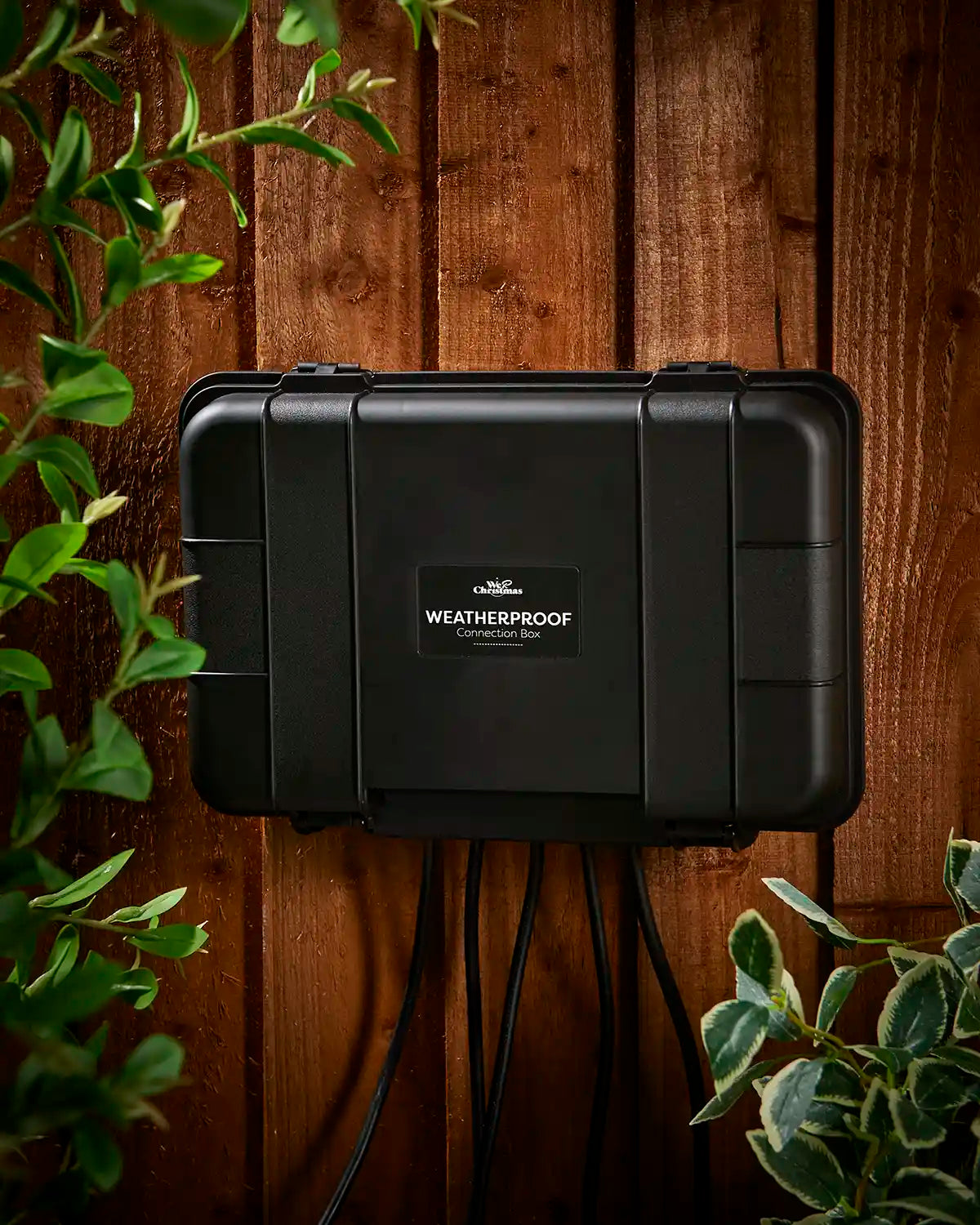 Black weatherproof case on a wooden fence with plants