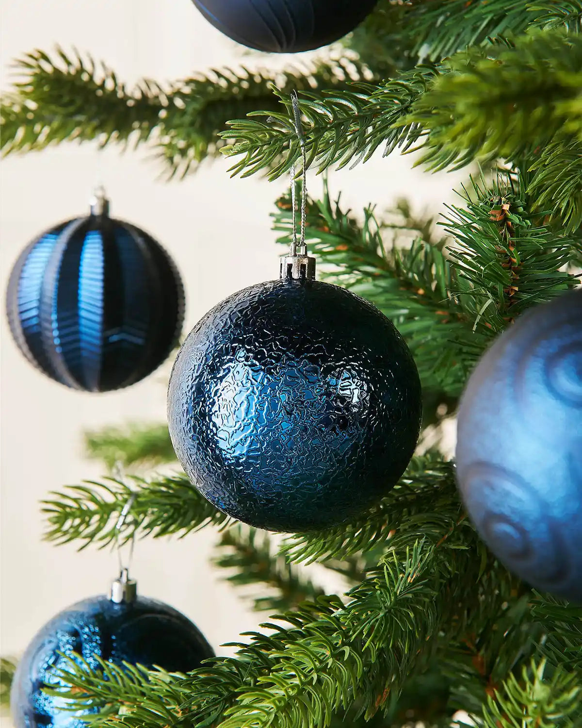 Blue glass ornaments on a Christmas tree