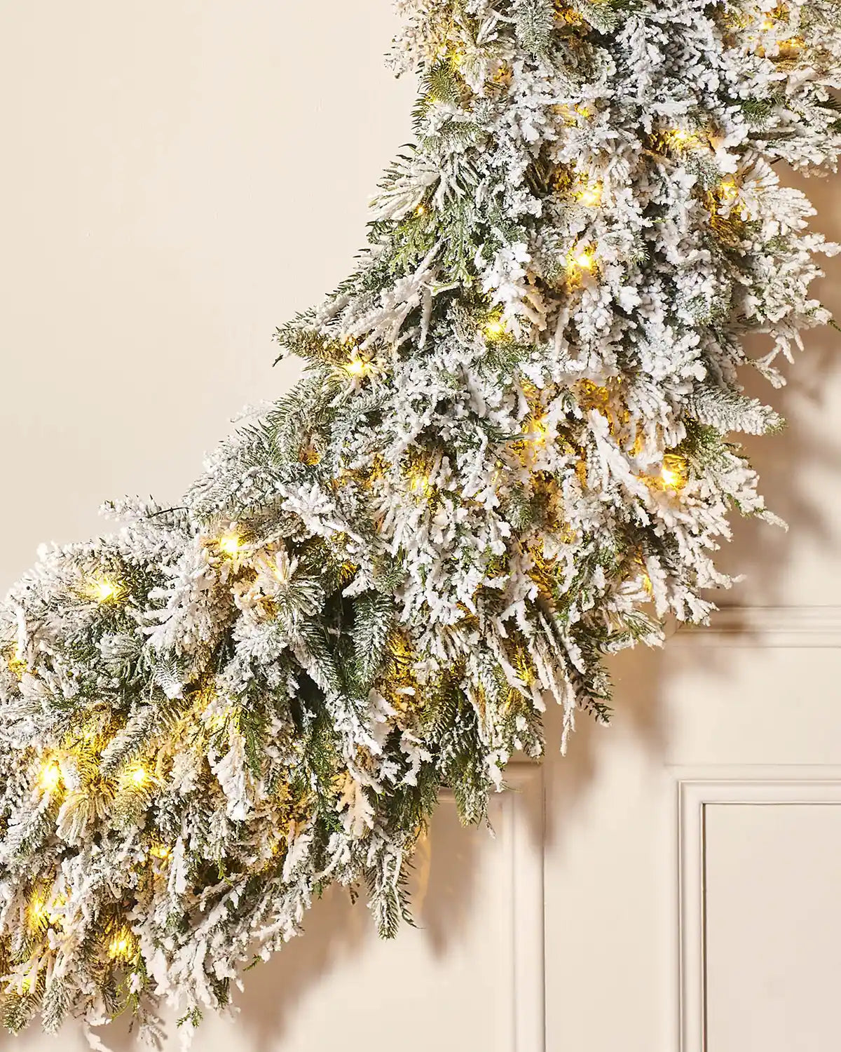 Bottom view of Pre-Lit Snow Flocked Natural Fir Majestic Wreath, 1.5 m on panel textured background