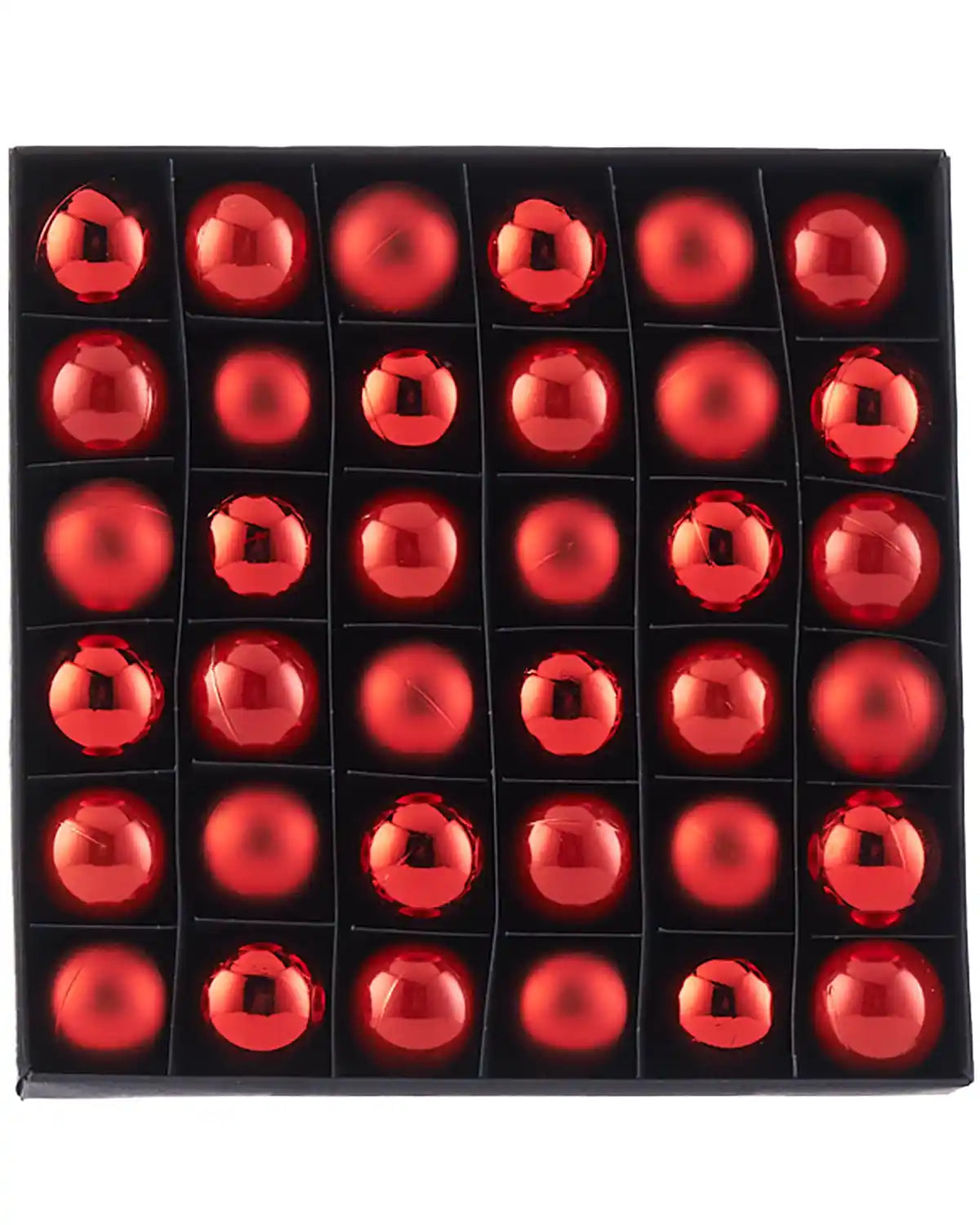 Box of red gloss, matt and pearl finishings on Christmas baubles on a white background