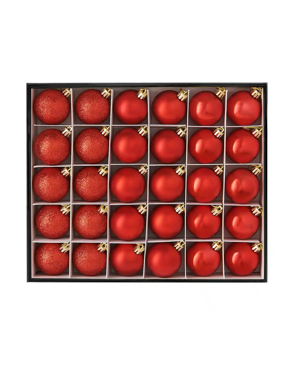Box of small red Christmas baubles on a white background