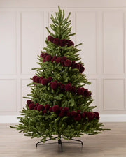 Burgundy Velvet Bauble Garland decorating a Christmas tree, featuring burgundy velvet baubles arranged along the garland