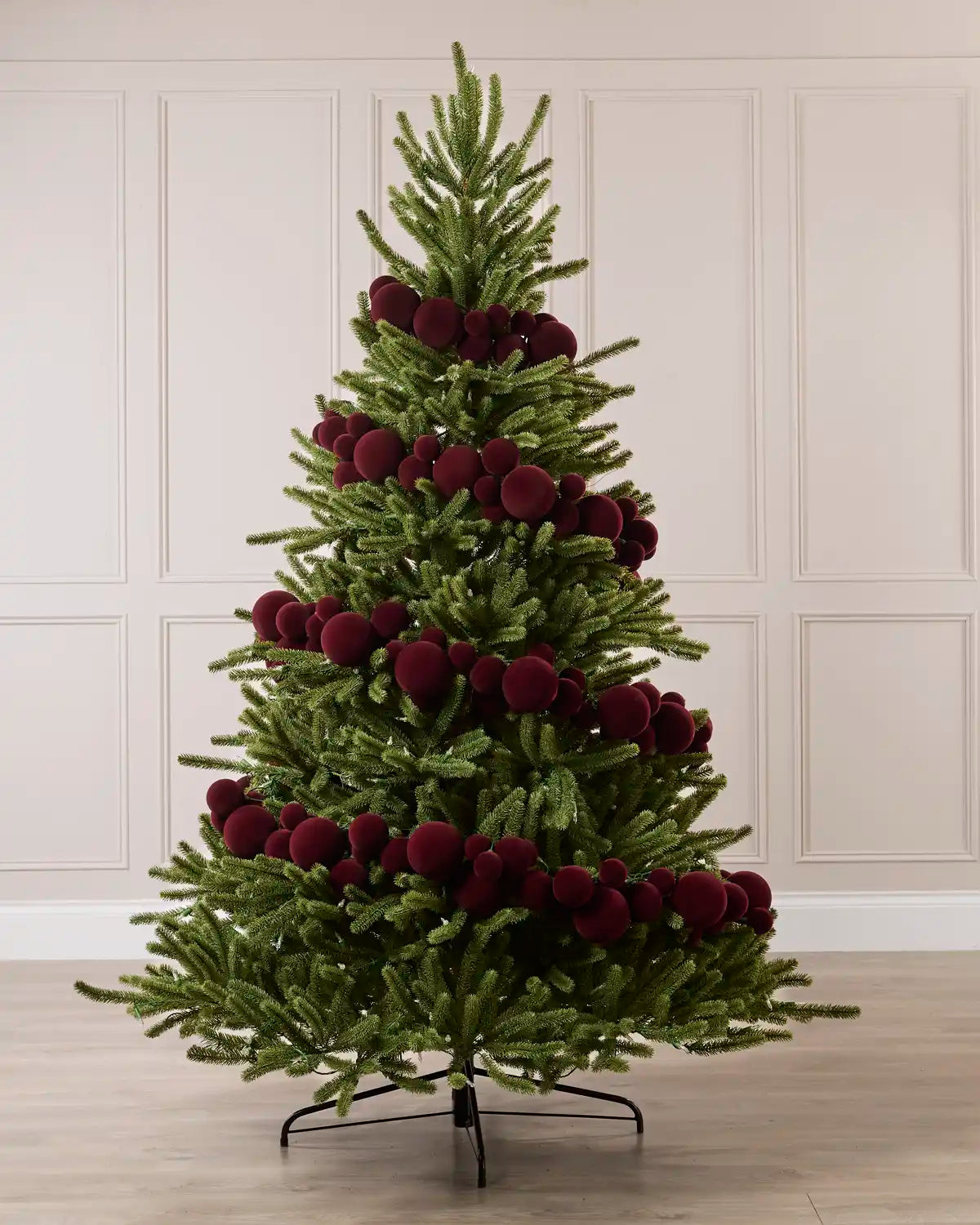 Burgundy Velvet Bauble Garland decorating a Christmas tree, featuring burgundy velvet baubles arranged along the garland