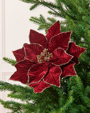 Burgundy glitter artificial poinsettia with gold-trimmed petals and a gold glitter berry center, displayed on a Christmas tree