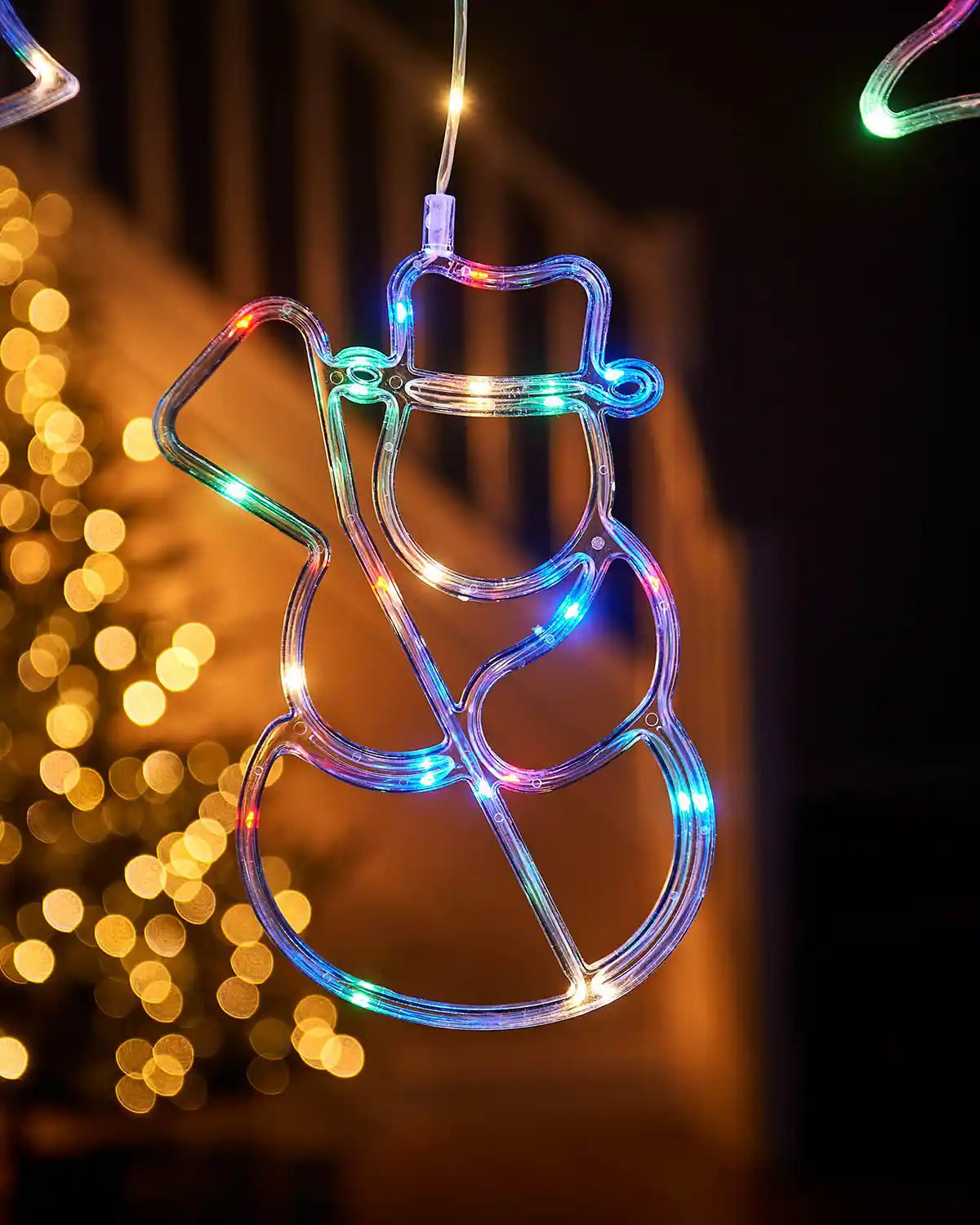 Close up of Christmas Snowman Character Curtain Light, 2.1 m on a window with a Christmas Tree in background