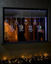 Christmas Character Curtain Light, 2.1 m on a window with Christmas tree in background 