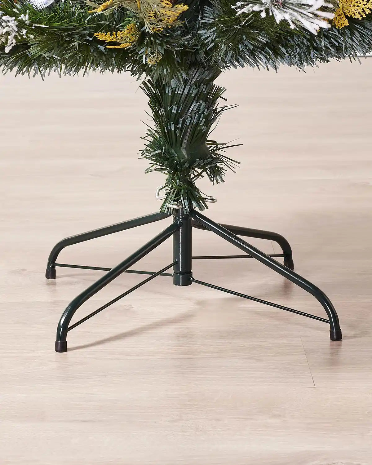 Christmas tree stand and base of tree on a wooden floor
