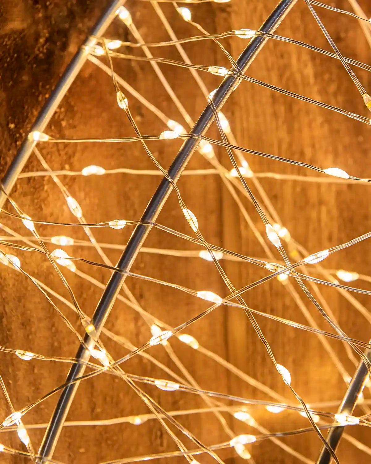 Close-up detail of the warm white lights wrapped around the metal frame of the Pre-Lit Twinkling Wreath Silhouette