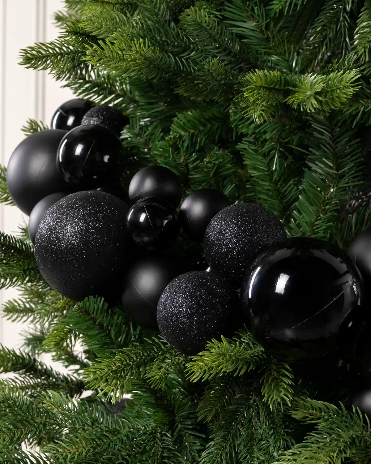 Close-up of Black Bauble Garland featuring black, glitter and metallic baubles