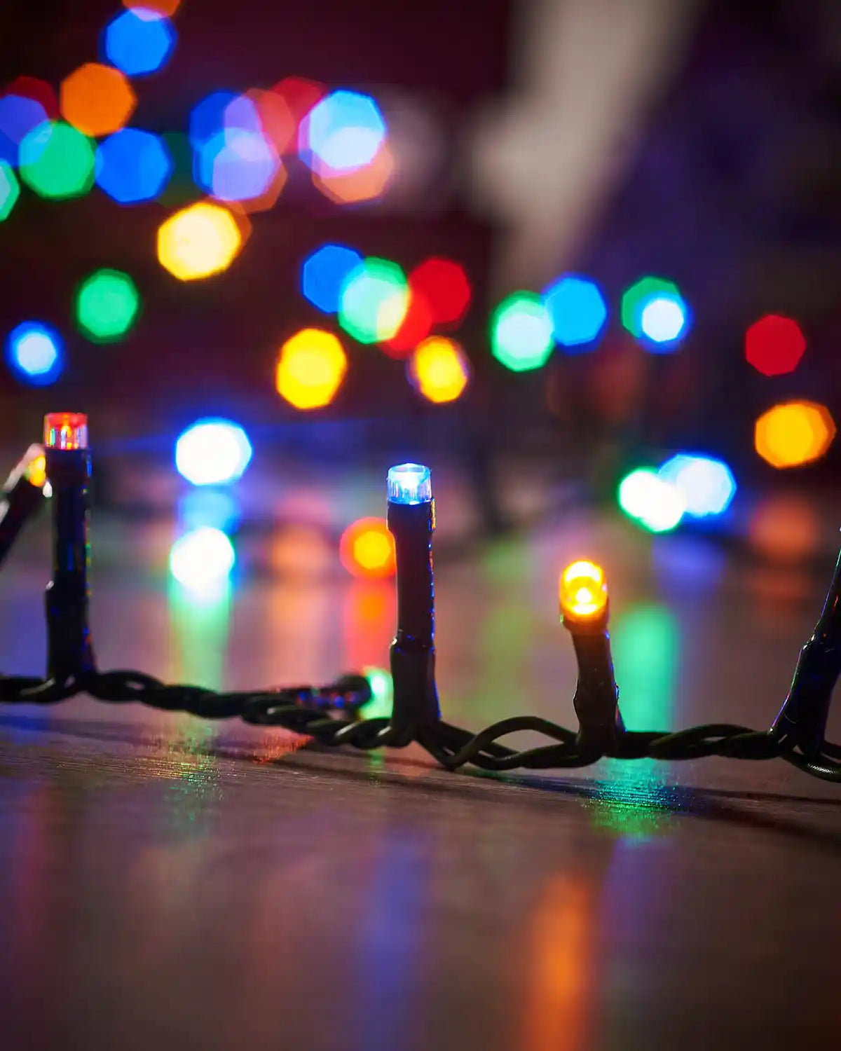 Close-up of Christmas lights with a colourful background