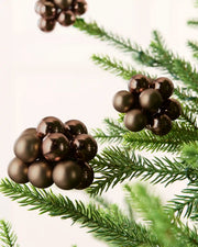 Close-up of Espresso glass berry cluster baubles with shiny and matt finishes on a Christmas tree.
