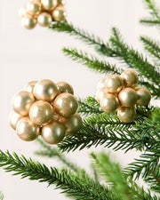Close-up of Latte glass berry cluster baubles with shiny and matt finishes on a Christmas tree.
