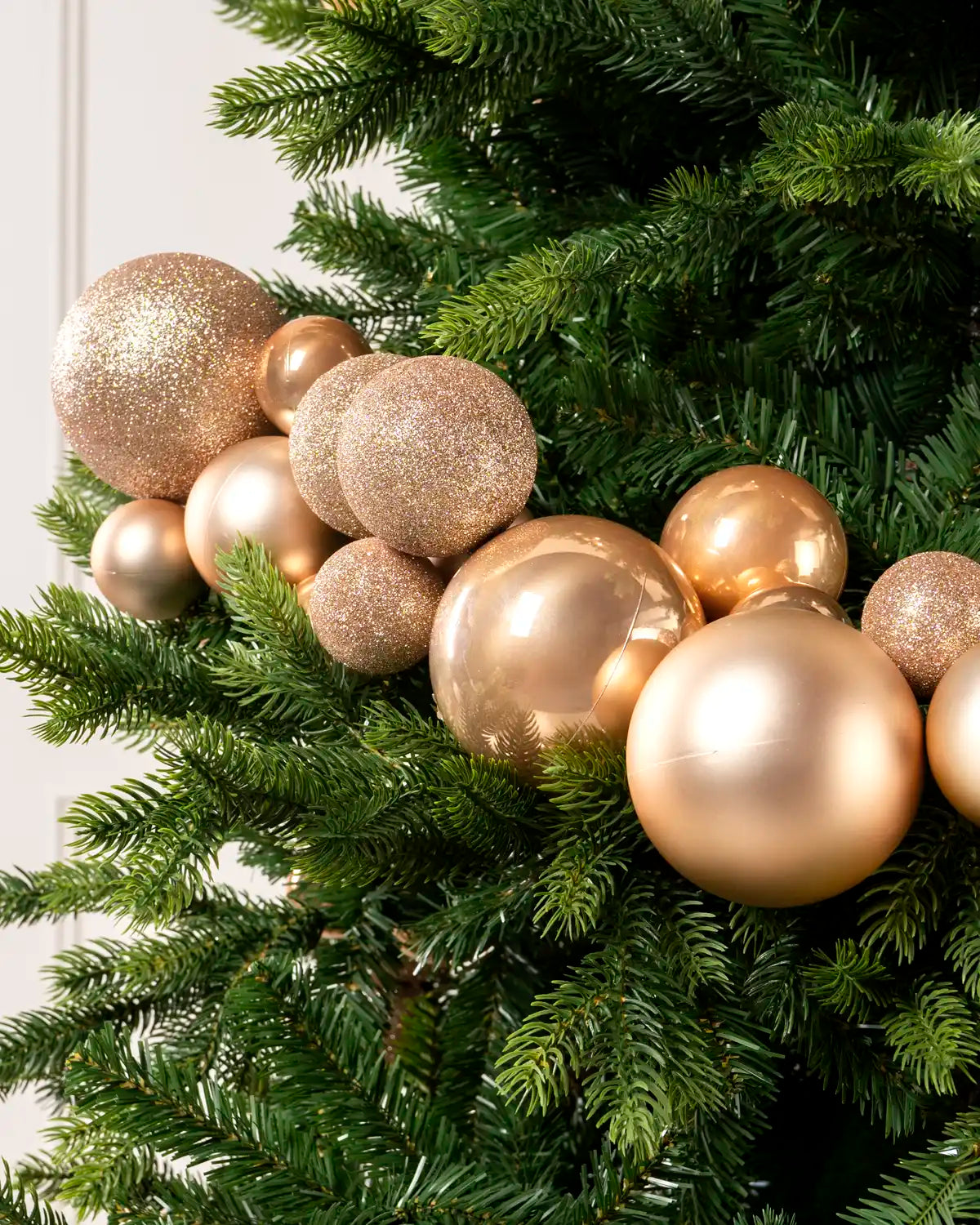 Close-up of Rose Gold Bauble Garland featuring rose gold, glitter and metallic baubles