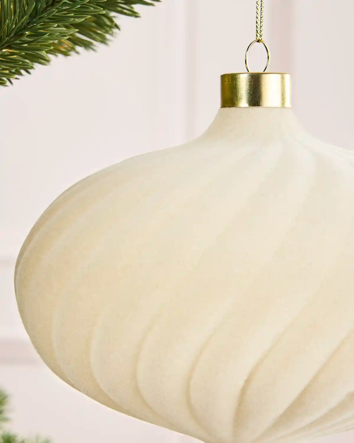 Close-up of a 15 cm latte velvet Spiral bauble showing its Spiral texture and gold hanging cap.
