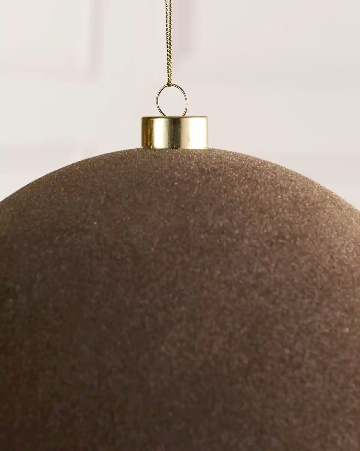 Close-up of a 20 cm Mocha velvet Traditional bauble showing its smooth texture and gold hanging cap.
