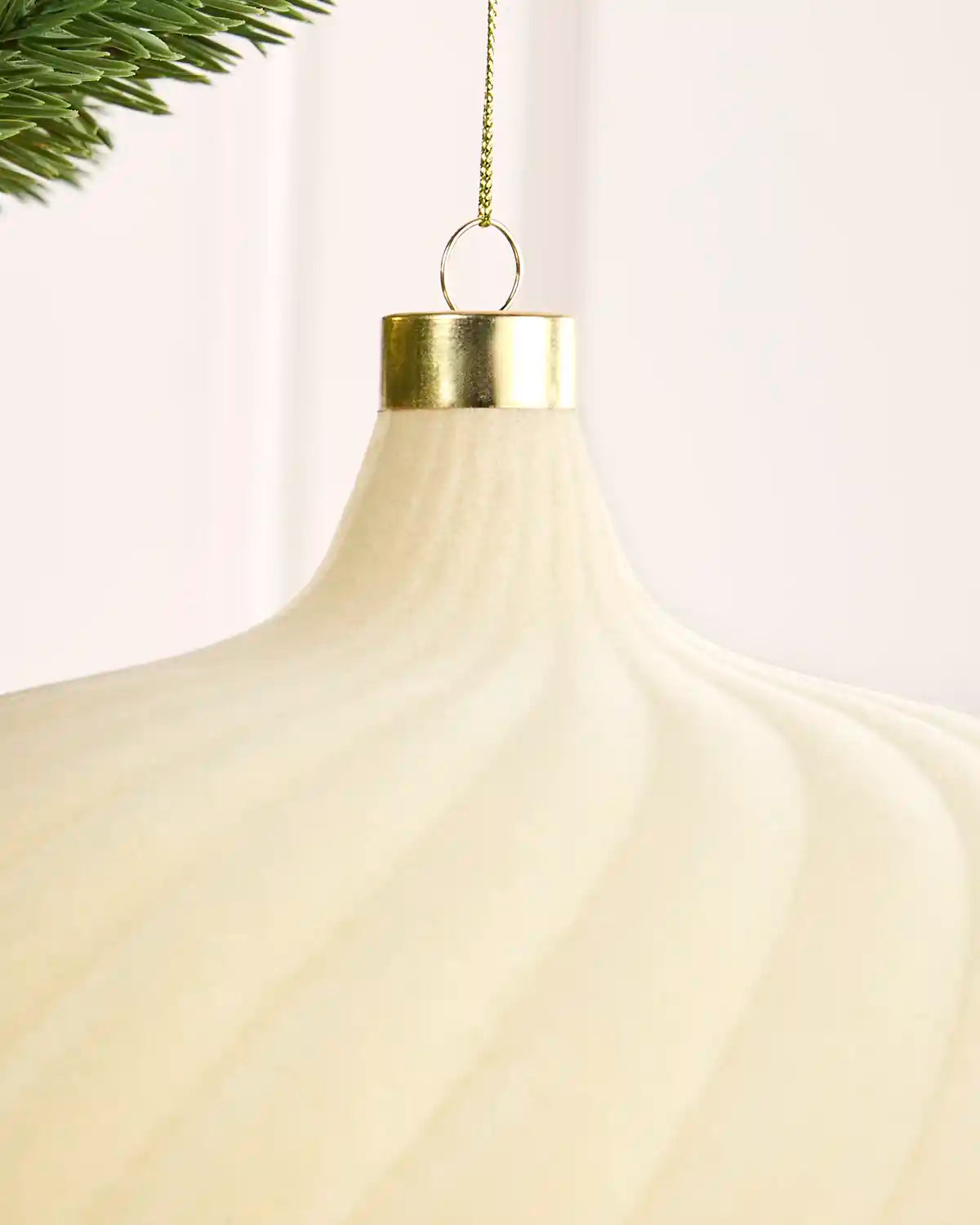 Close-up of a 20 cm latte velvet Spiral bauble showing its Spiral texture and gold hanging cap.
