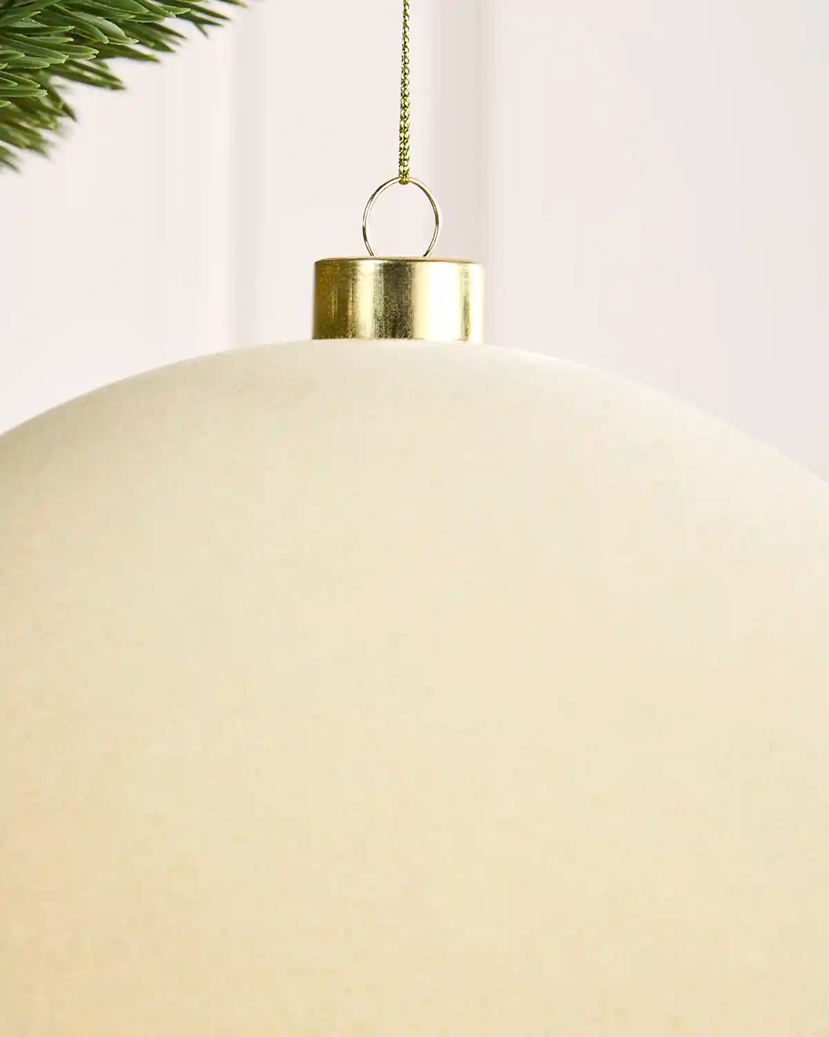 Close-up of a 20 cm latte velvet Traditional bauble showing its smooth texture and gold hanging cap.
