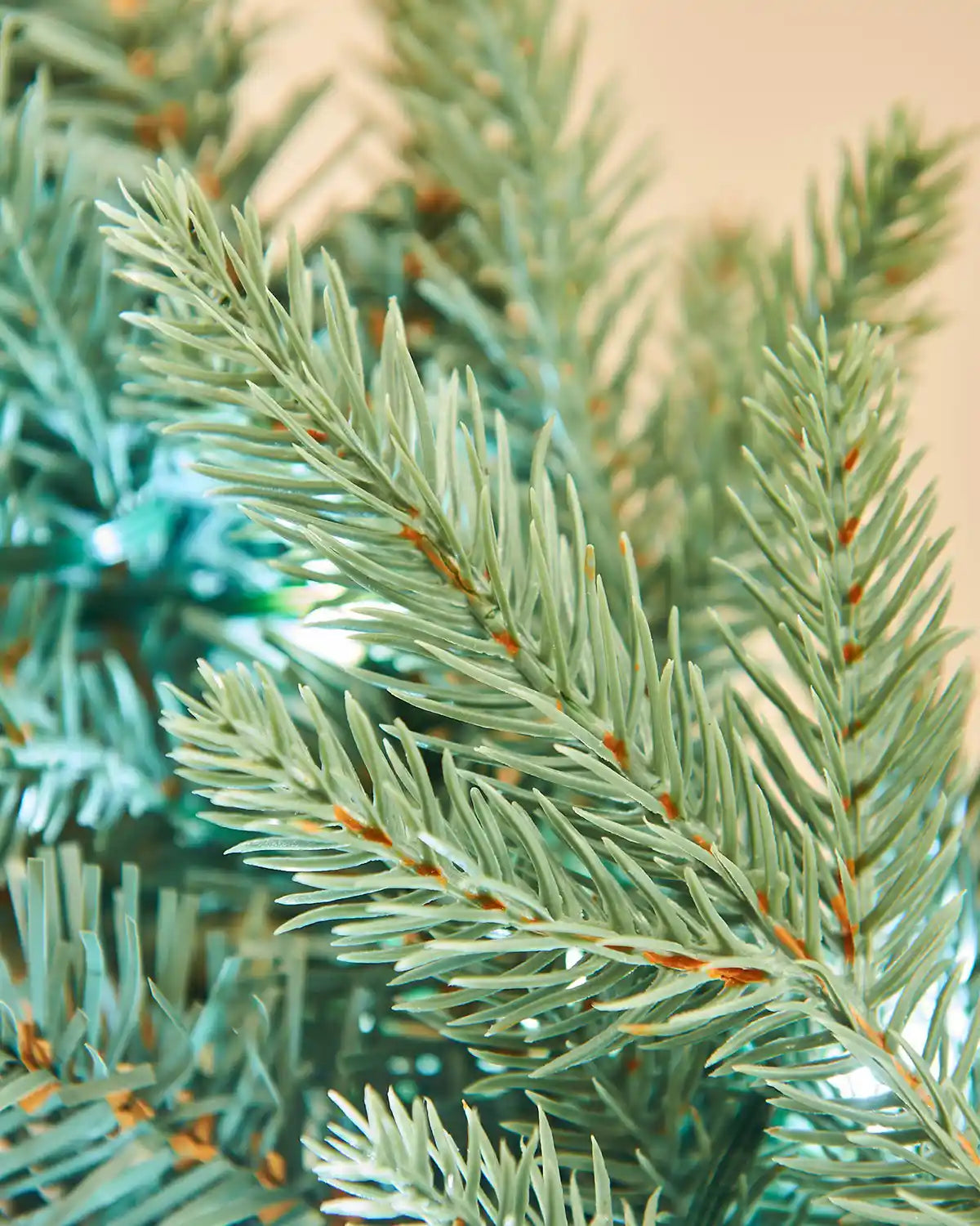 Close-up of a Christmas garland with ice white lights on a beige background