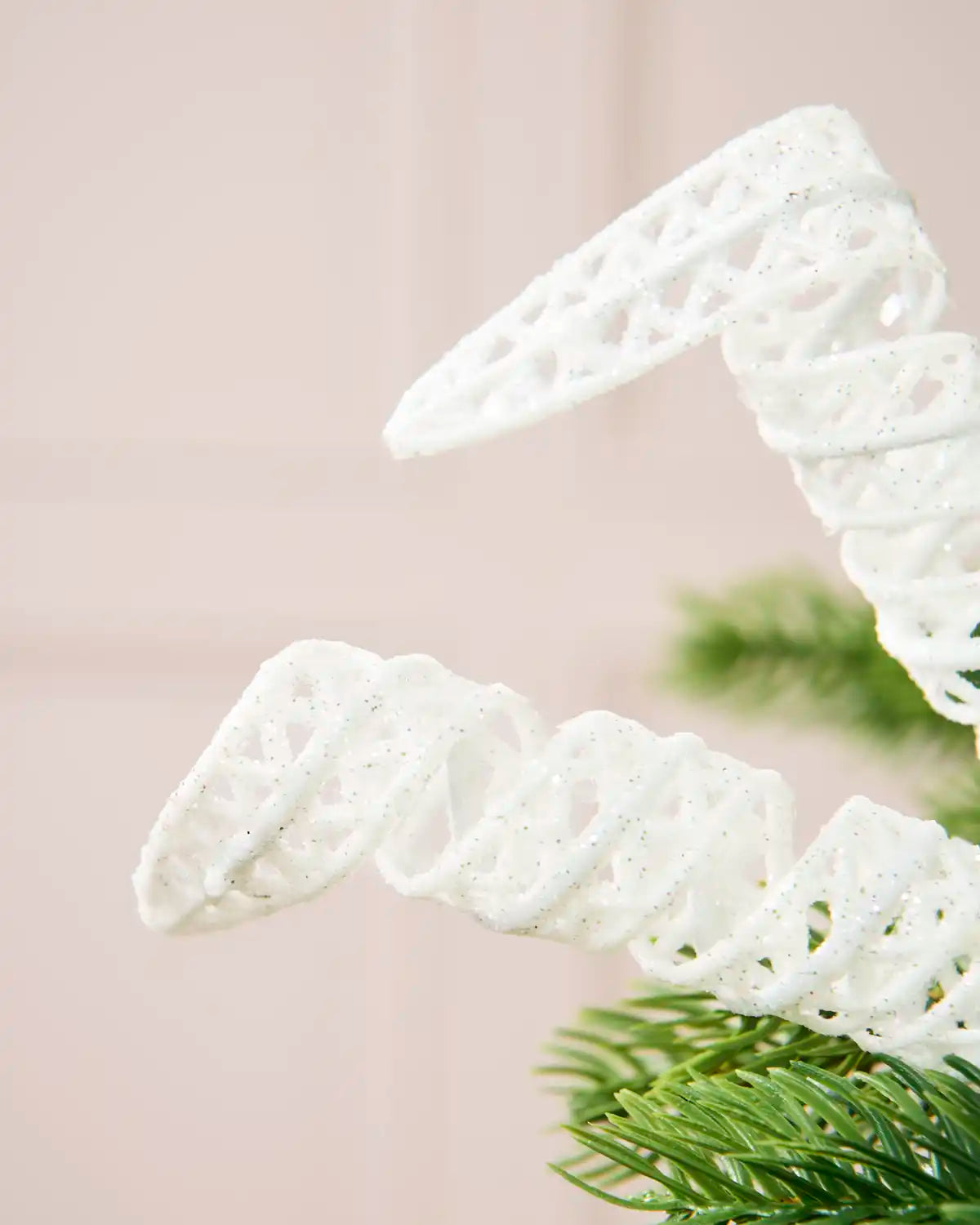 Close-up of a White Glitter Spiral Pick attached to a Christmas tree branch