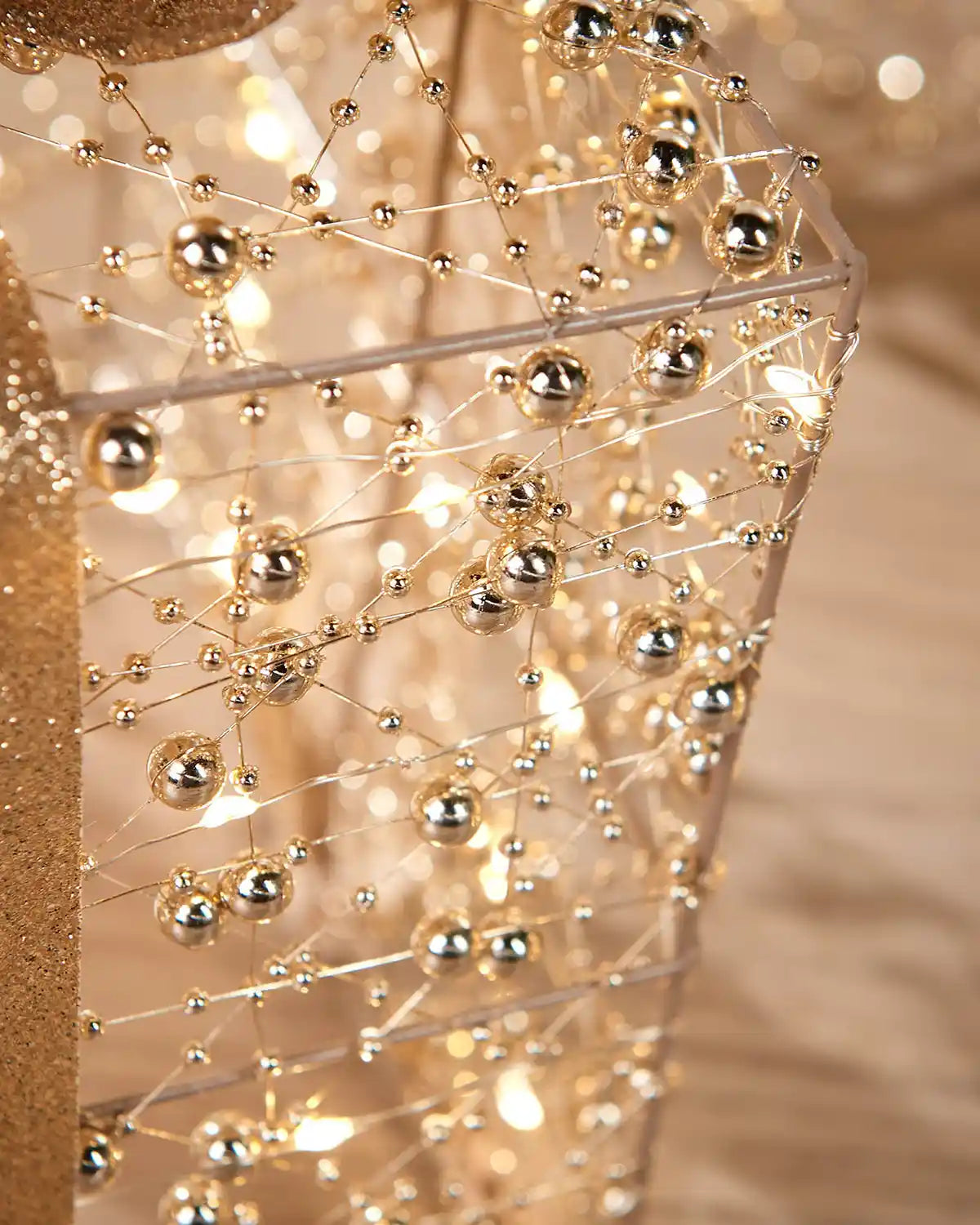 Close-up of a decorative light up copper present box with gold beads 