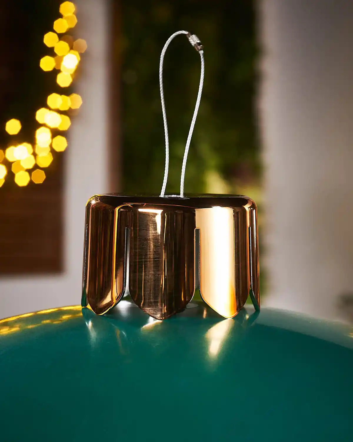 Close-up of a gold crown cap for inflatable extra green large bauble on a blurry background
