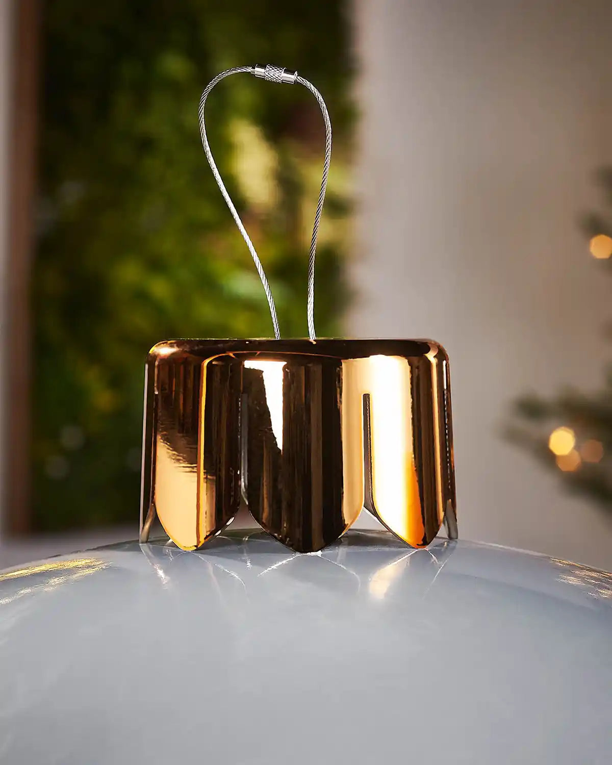 Close-up of a gold crown cap for inflatable large silver bauble on a blurry background
