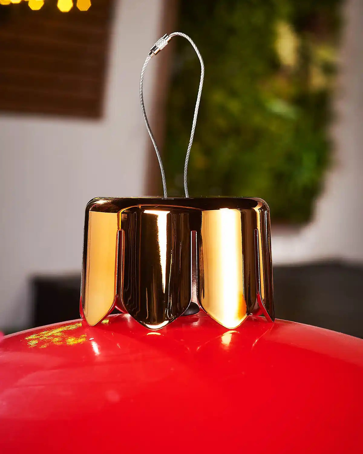 Close-up of a gold crown cap for inflatable red extra large bauble on a blurry background
