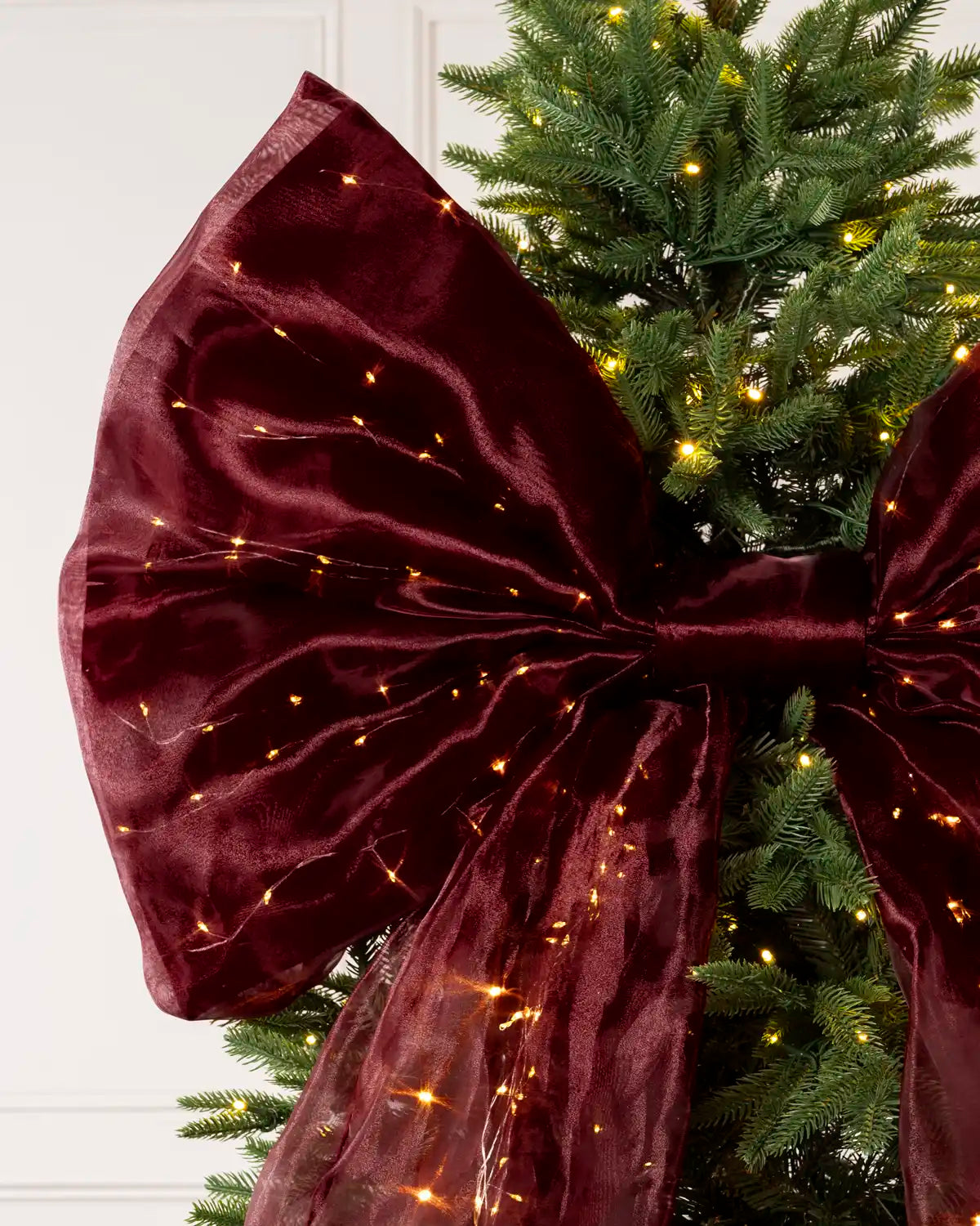 Close-up of a large burgundy Christmas bow