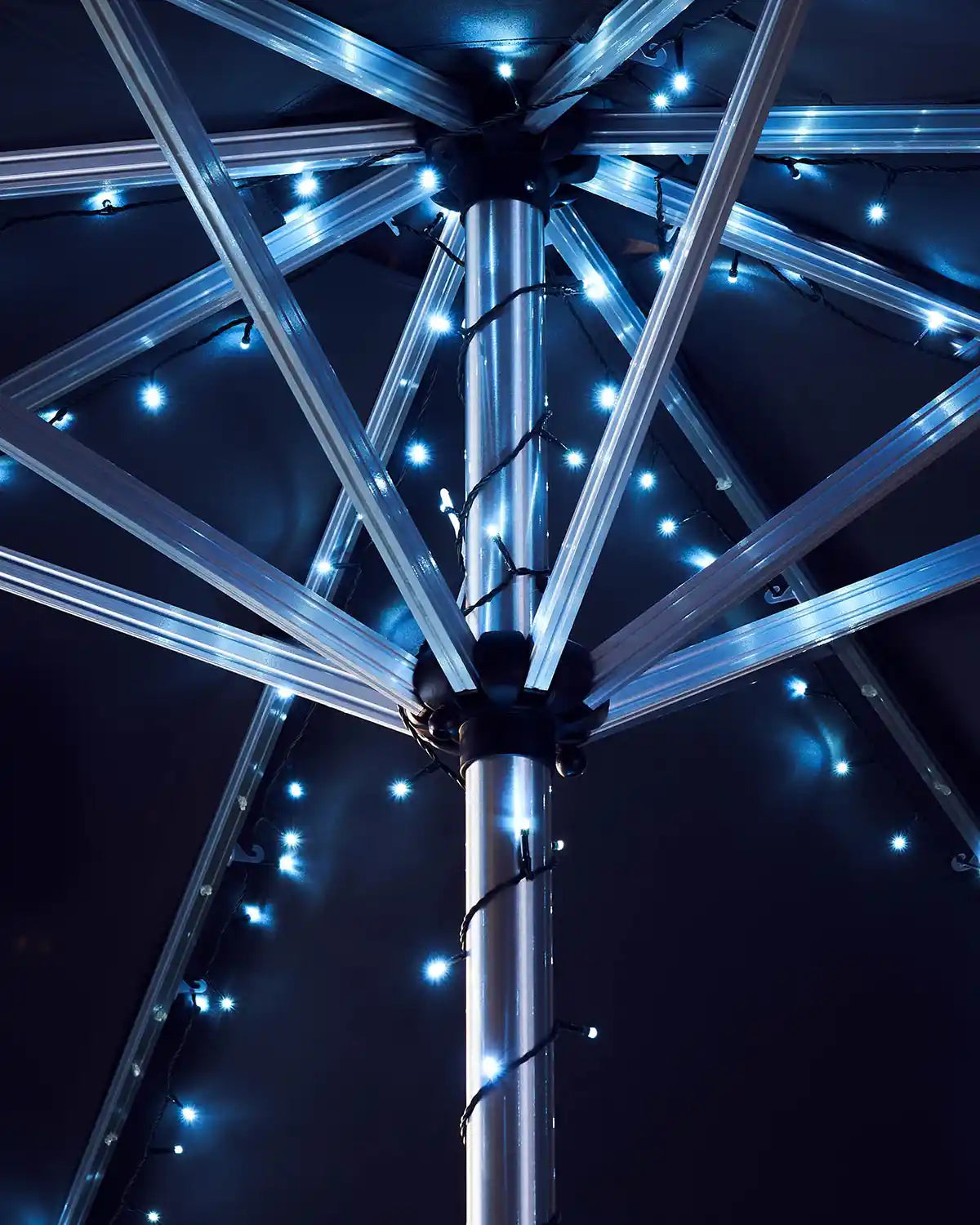 Close-up of a metallic outdoor umbrella with Ice white lights 
