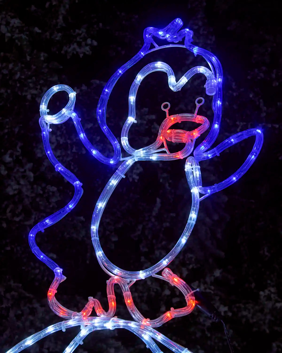 Close-up of a pre-lit penguin rope light silhouette glowing in blue and white lights, with red illuminated beak and feet details.