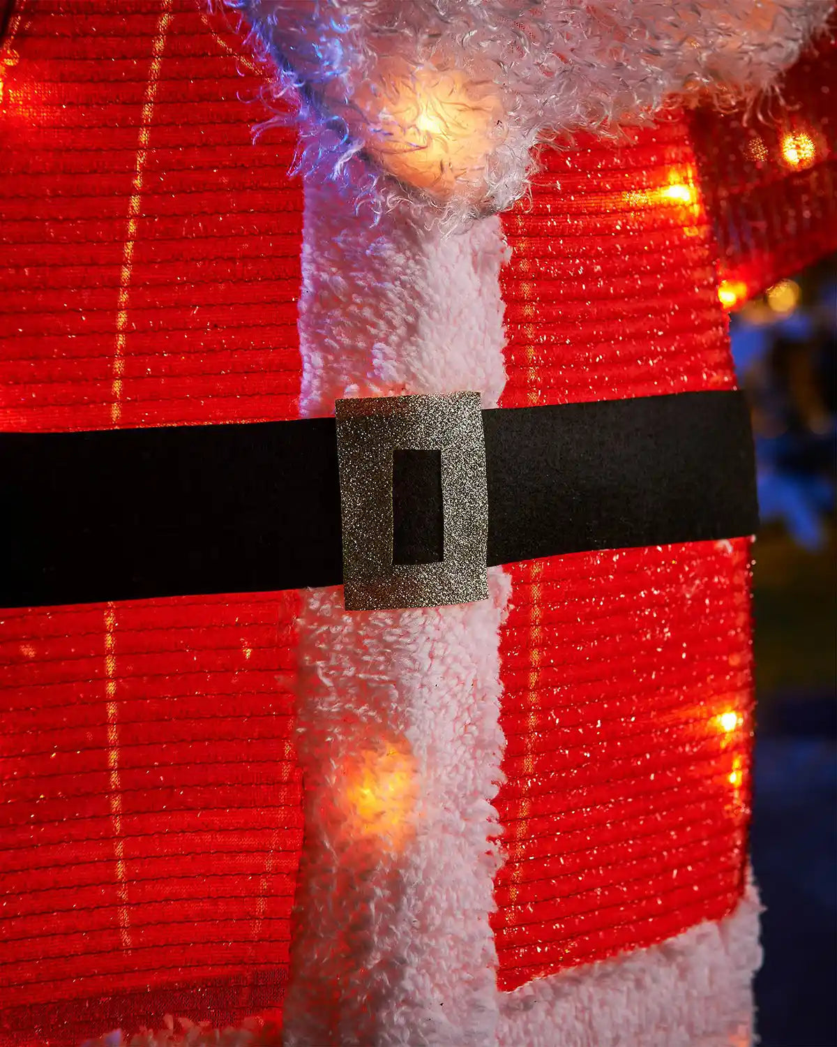 Close-up of a red and white striped fabric with a black belt buckle, possibly part of a festive decoration.