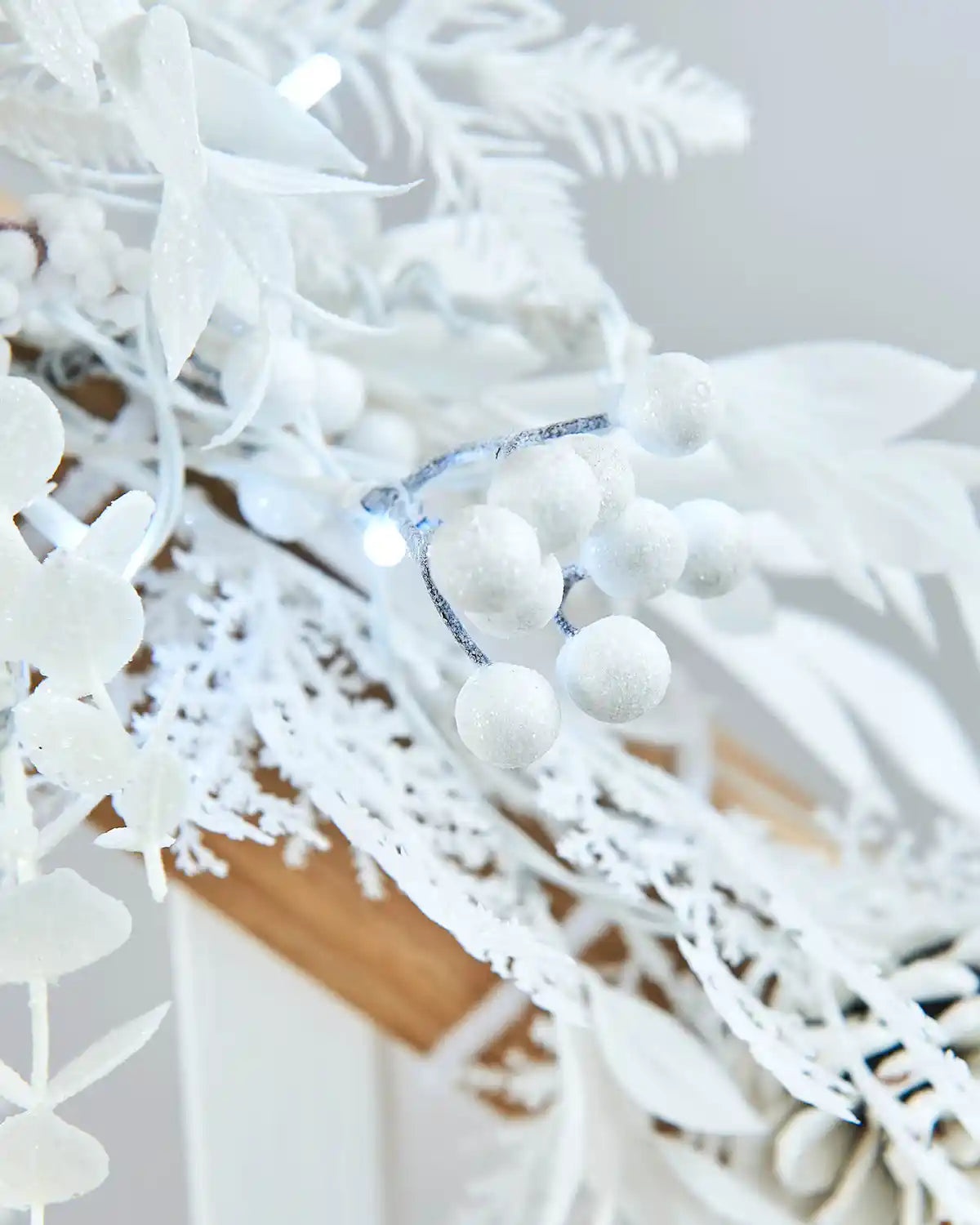 Close-up of a white snow berries and ice white lights 