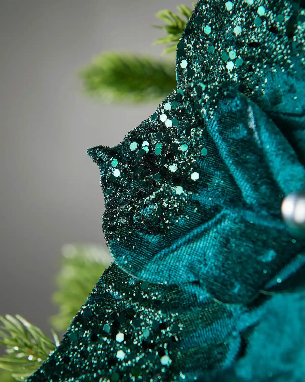 Close-up of an Emerald glittery fabric with a blurred green background