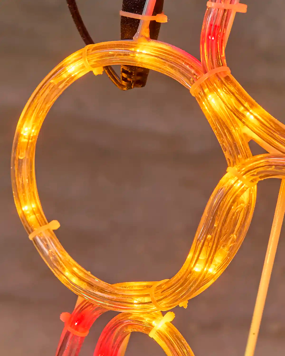 Close-up of an orange rope-light section, showing the individual lights and clear tubing
