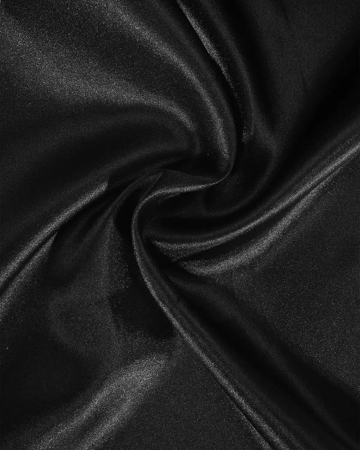 Close-up of black satin fabric with a swirl pattern