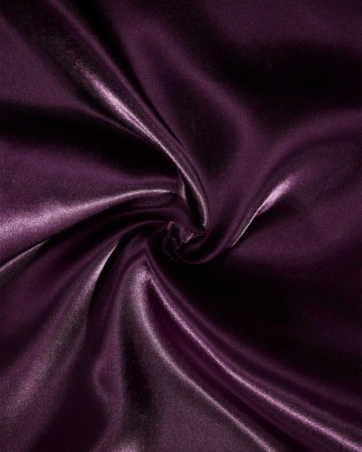 Close-up of glossy purple satin ribbon fabric gathered into soft folds, highlighting its rich colour and satin texture
