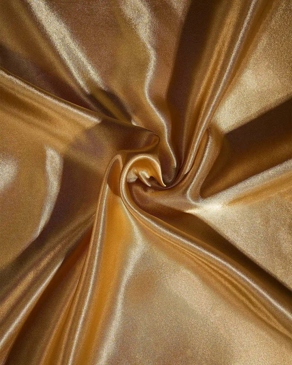 Close-up of gold satin fabric with swirl pattern