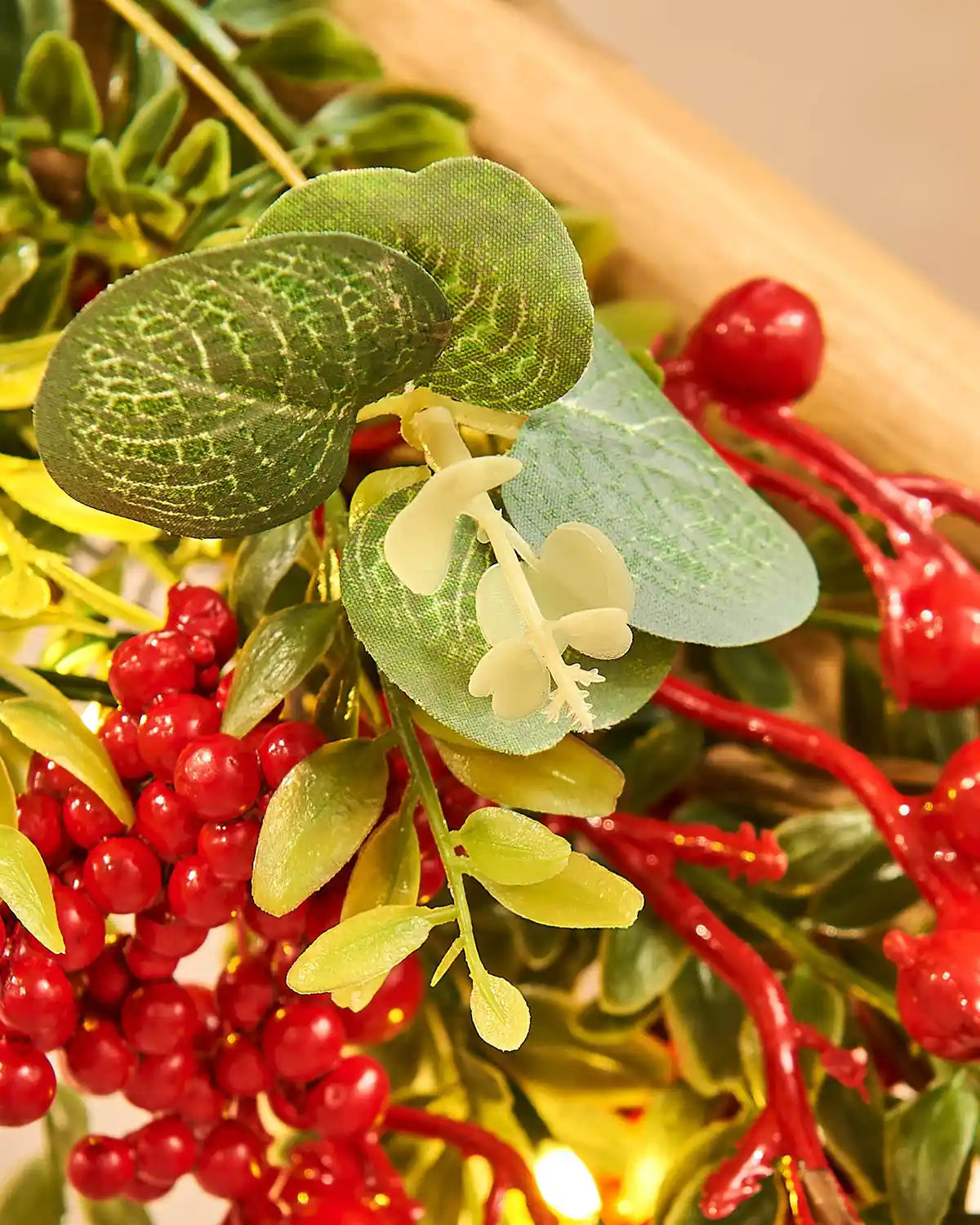 Close-up of mistletoe with red berries and green leaves on a blurred background