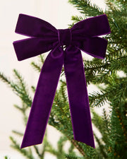 Close-up of purple velvet Double Bow attached to a Christmas tree branch