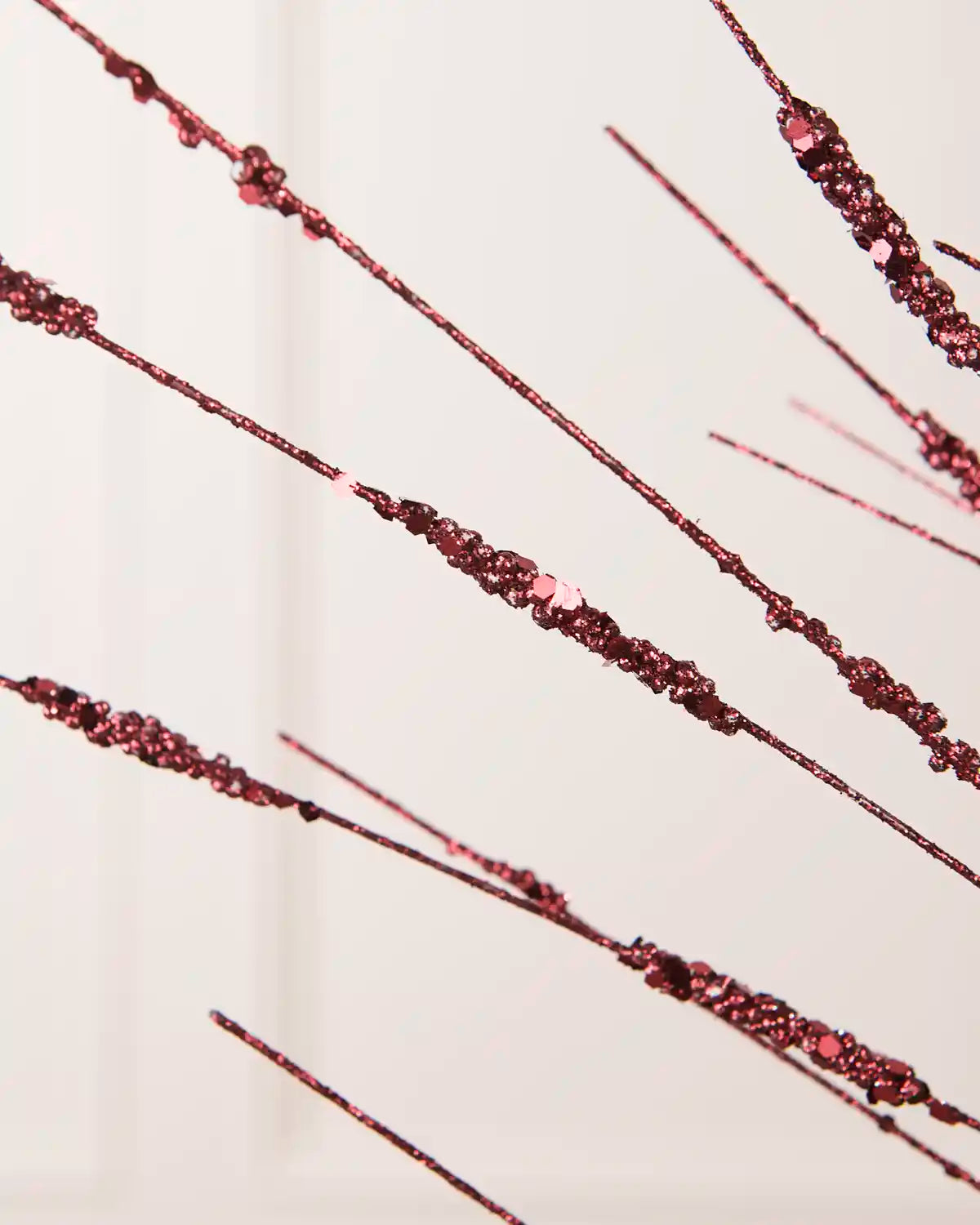 Close-up of the Burgundy Glitter Wispy Spray, showing textured glitter-covered stems and clustered decorative details
