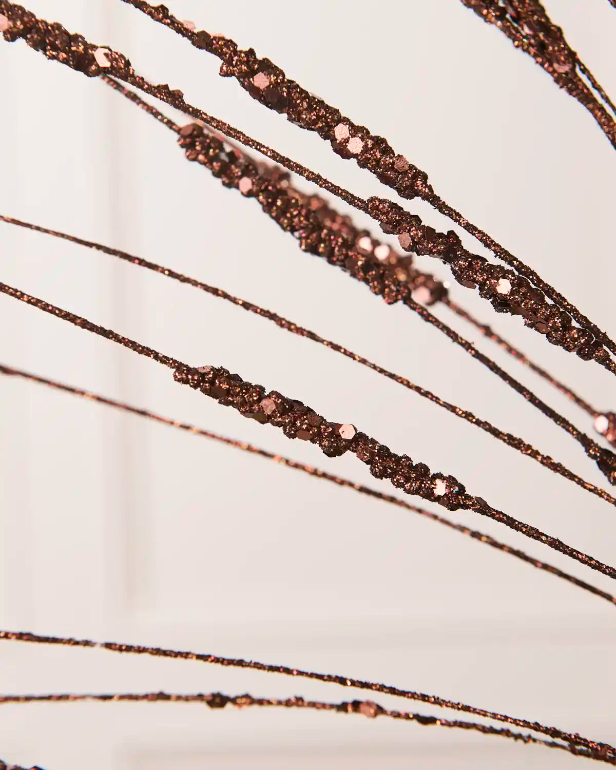 Close-up of the Espresso Glitter Wispy Spray, showing textured glitter-covered stems and clustered decorative details
