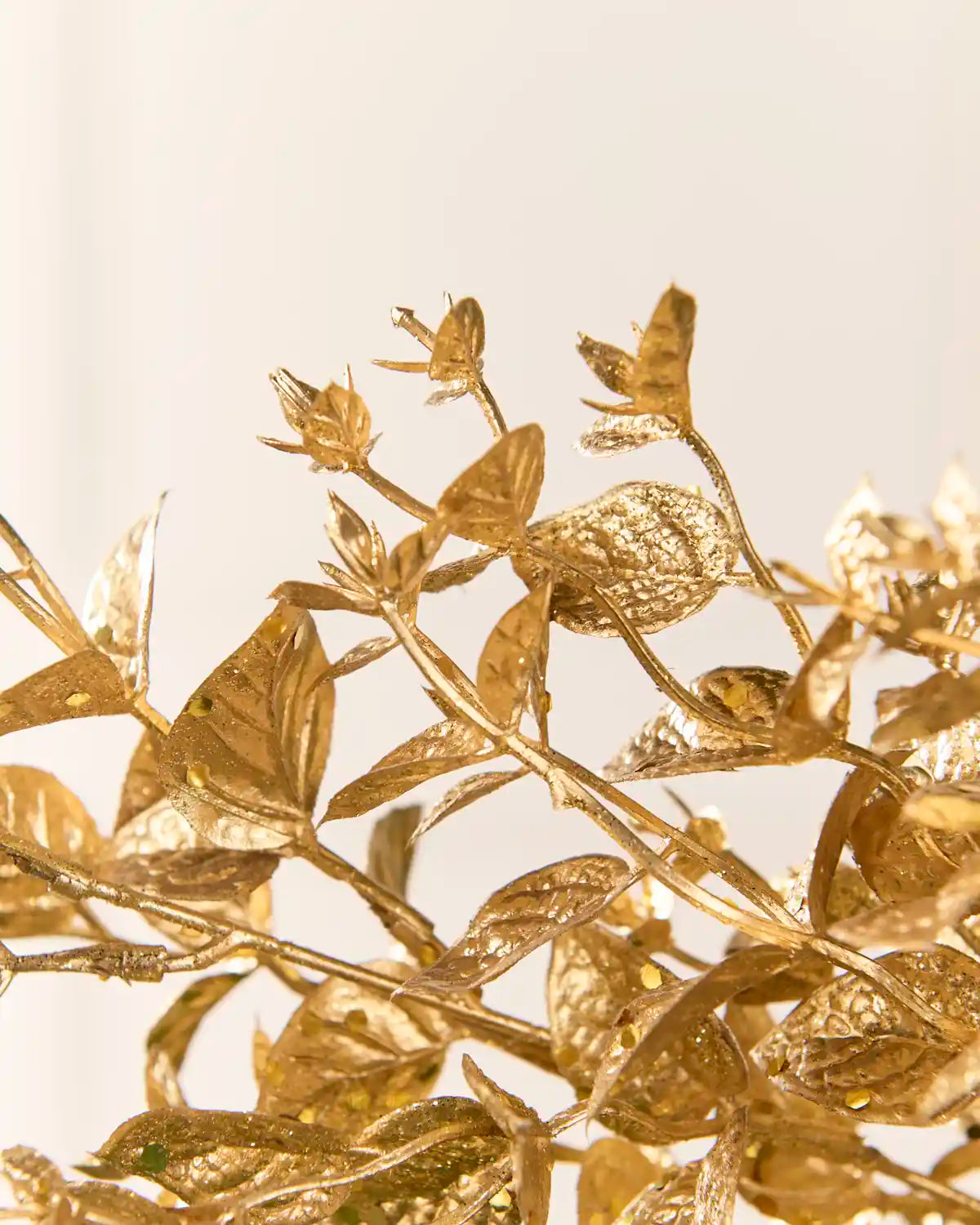 Close-up of the Gold Foliage Spray highlighting its textured metallic gold leaves and branching stems