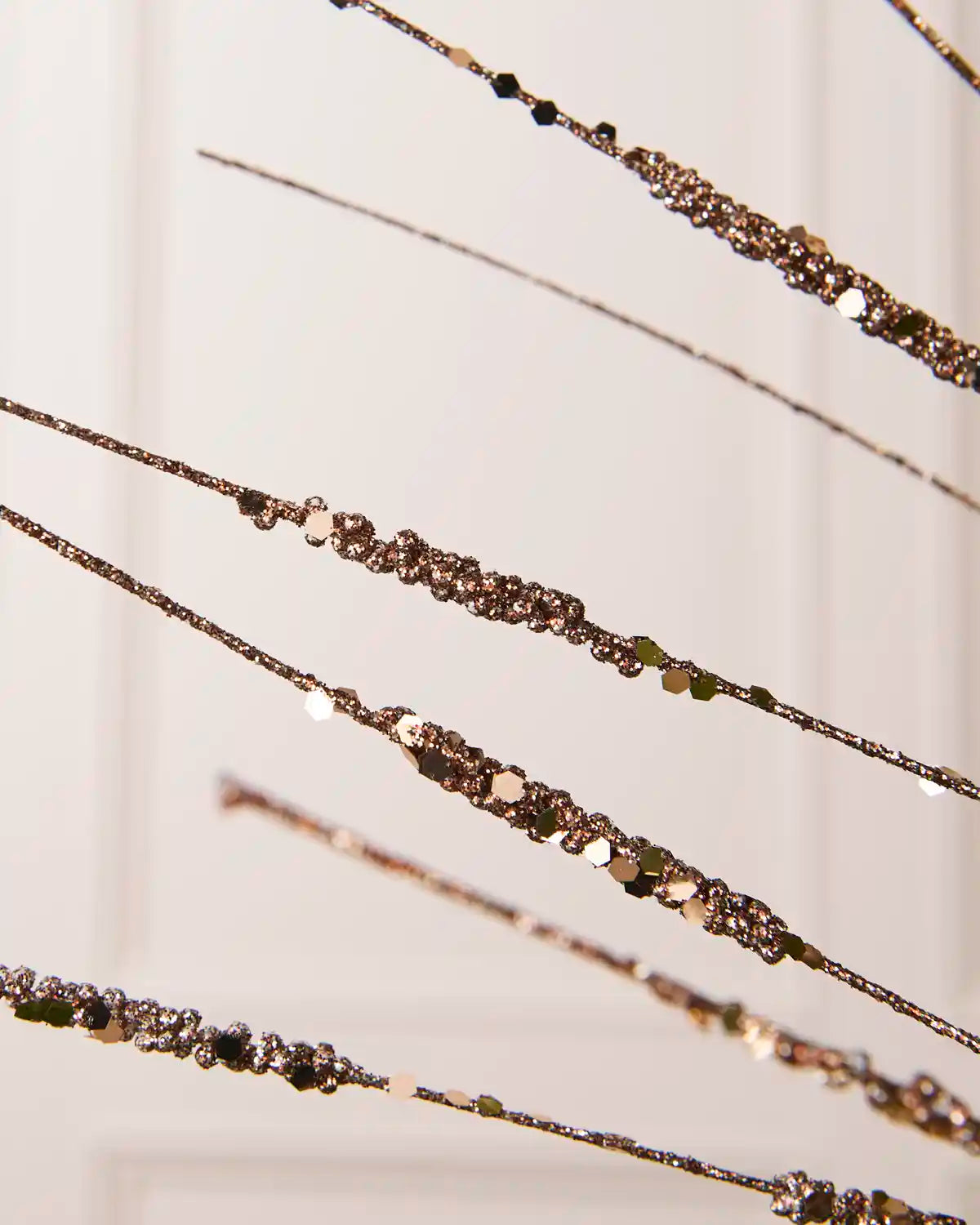 Close-up of the Mocha Glitter Wispy Spray, showing textured glitter-covered stems and clustered decorative details
