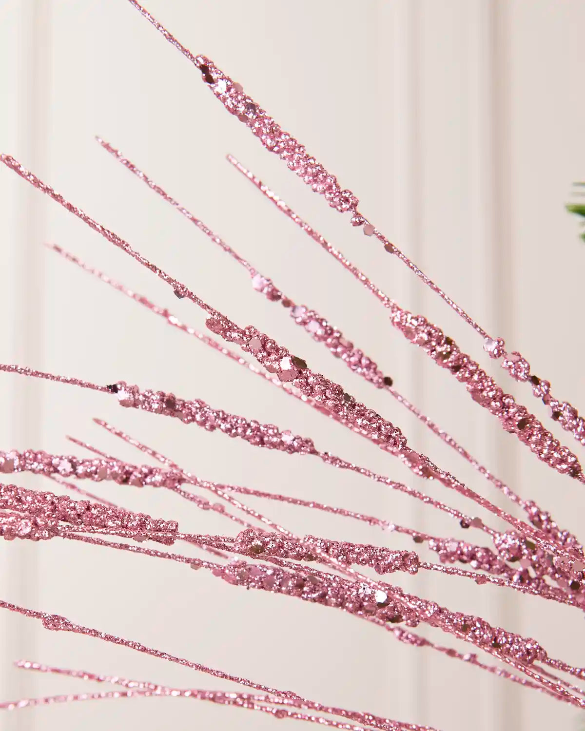 Close-up of the Pink Glitter Wispy Spray, showing textured glitter-covered stems and clustered decorative details
