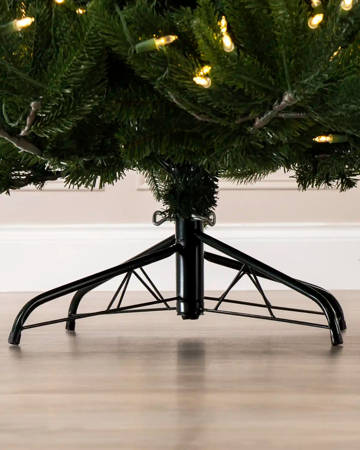 Close-up of the Pre-Lit Hawthorn Spruce Christmas Tree’s black metal stand