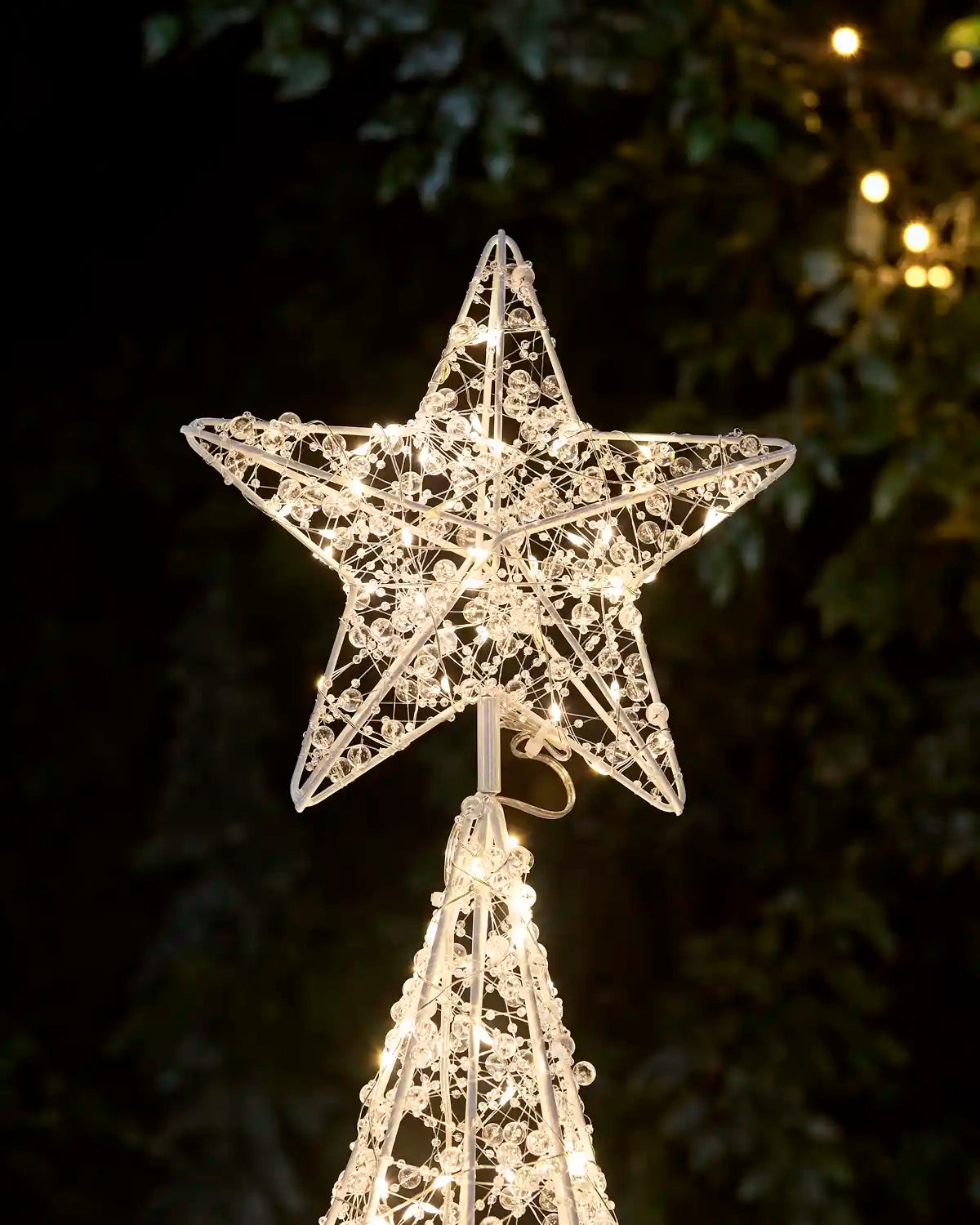 Close-up of the Pre-Lit Twinkling Beaded Christmas Tree showing its illuminated decorative star topper and intricate beaded wire design