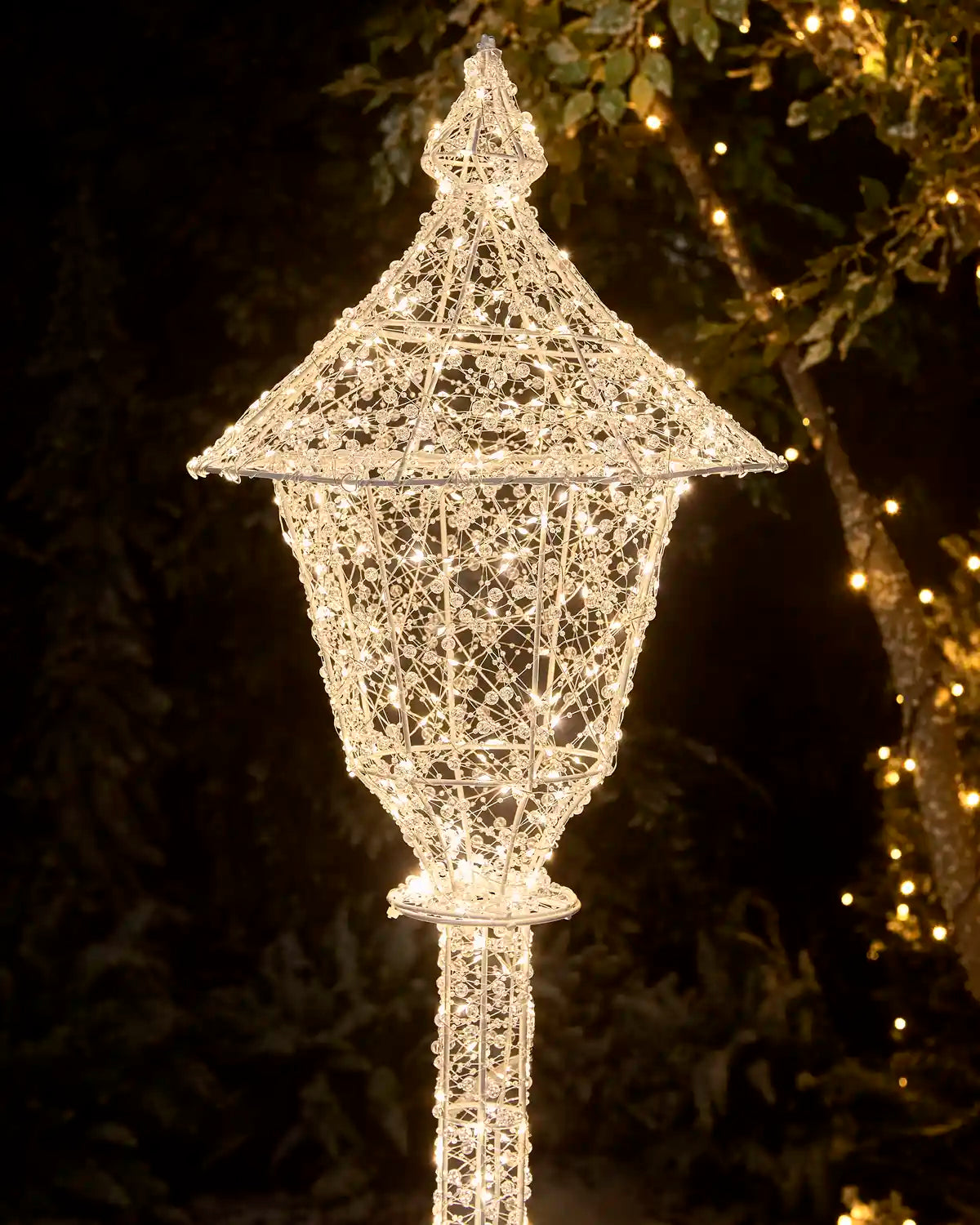 Close-up of the Pre-Lit Twinkling Beaded Lamp Post showing its illuminated decorative lantern top and beaded wire design