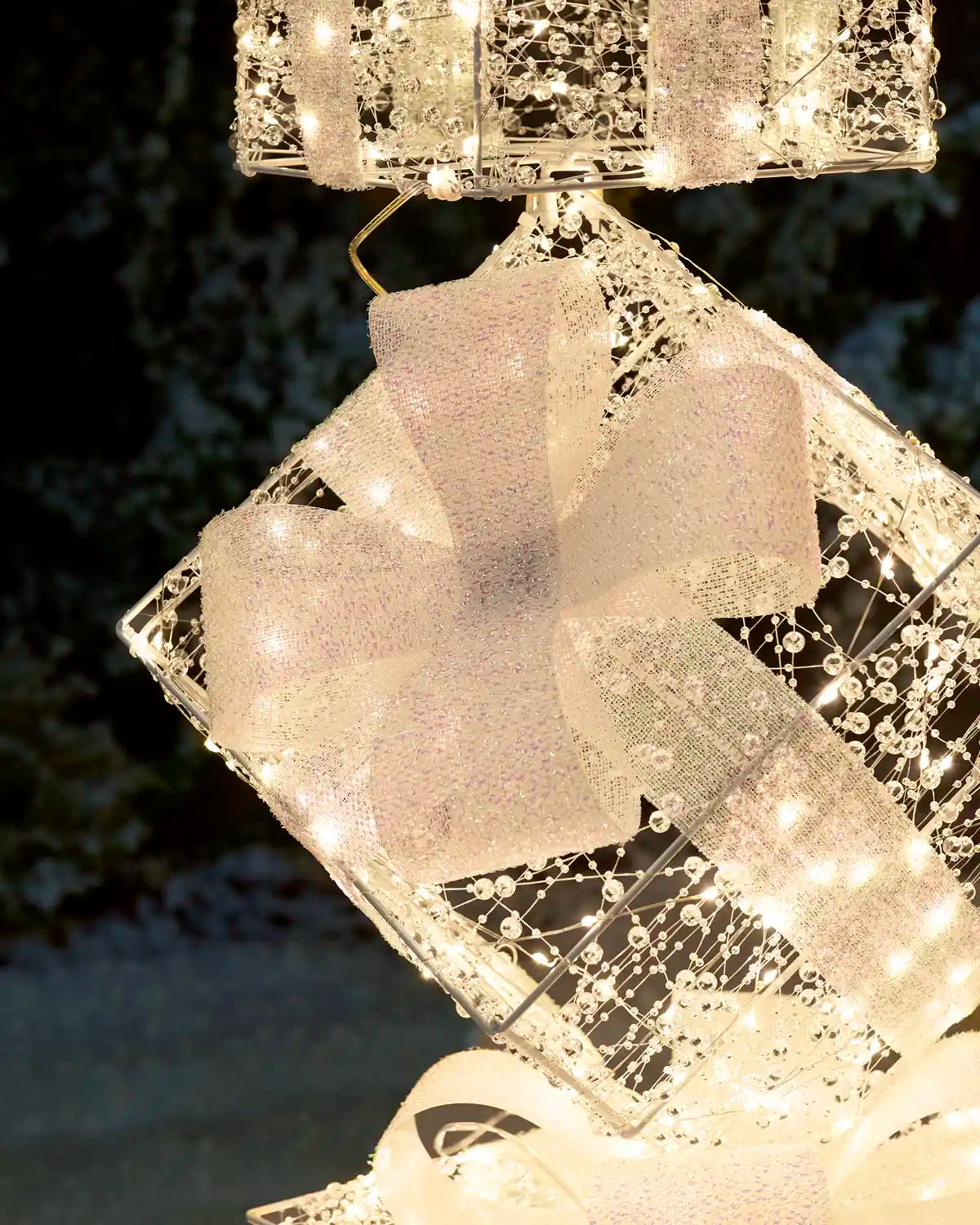 Close-up of the Pre-Lit Twinkling Present Stack showing its illuminated decorative details and intricate design
