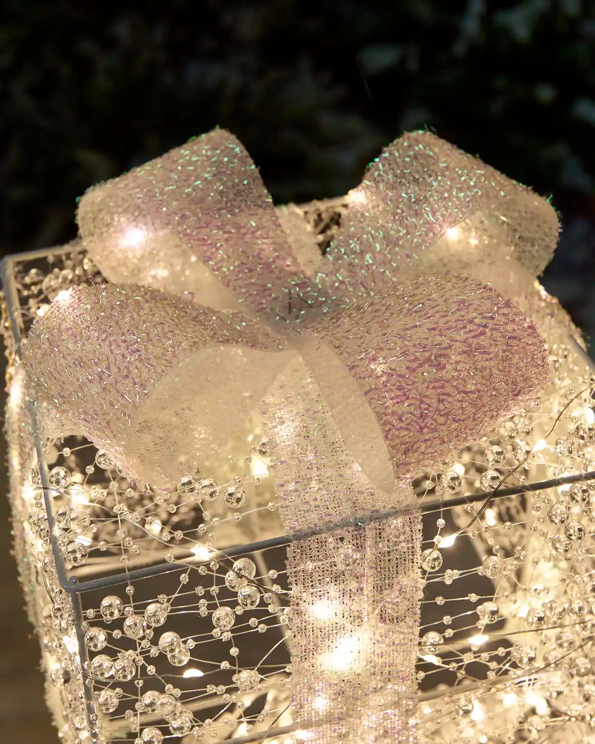 Close-up of the decorative bow detailing and warm white lights on the Pre-Lit Twinkling Present Stack